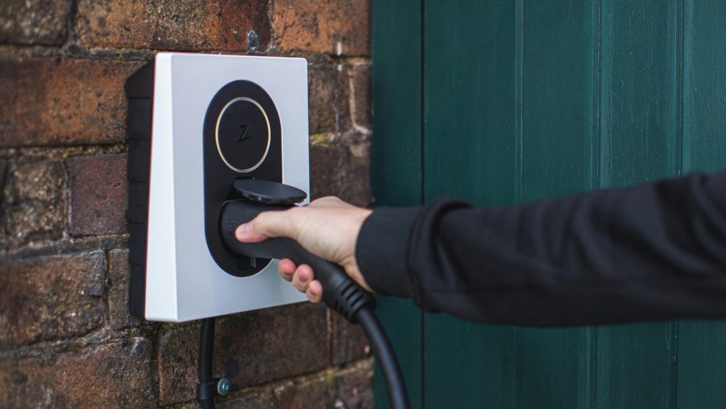 a person is plugging in to a wall mounted device